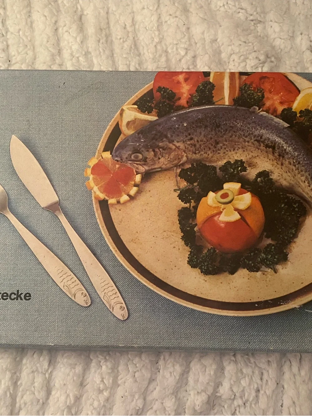Silver Stainless Steel Fish-Engraved Flatware Knife Set on Blue Placemat